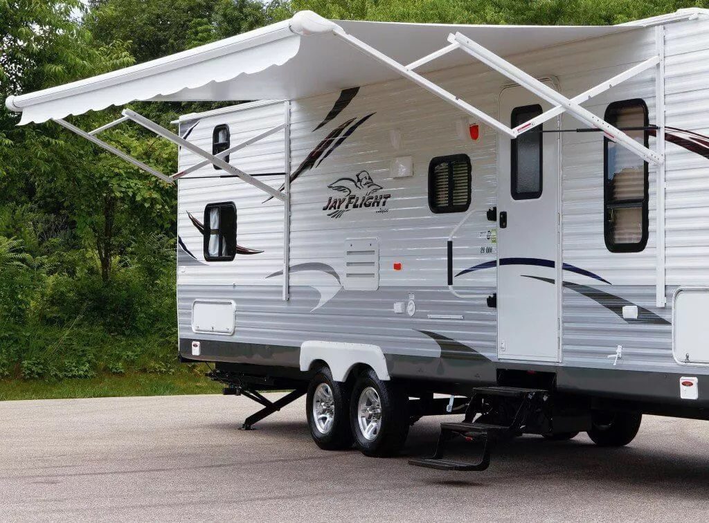  A white scissor arm awning on an RV