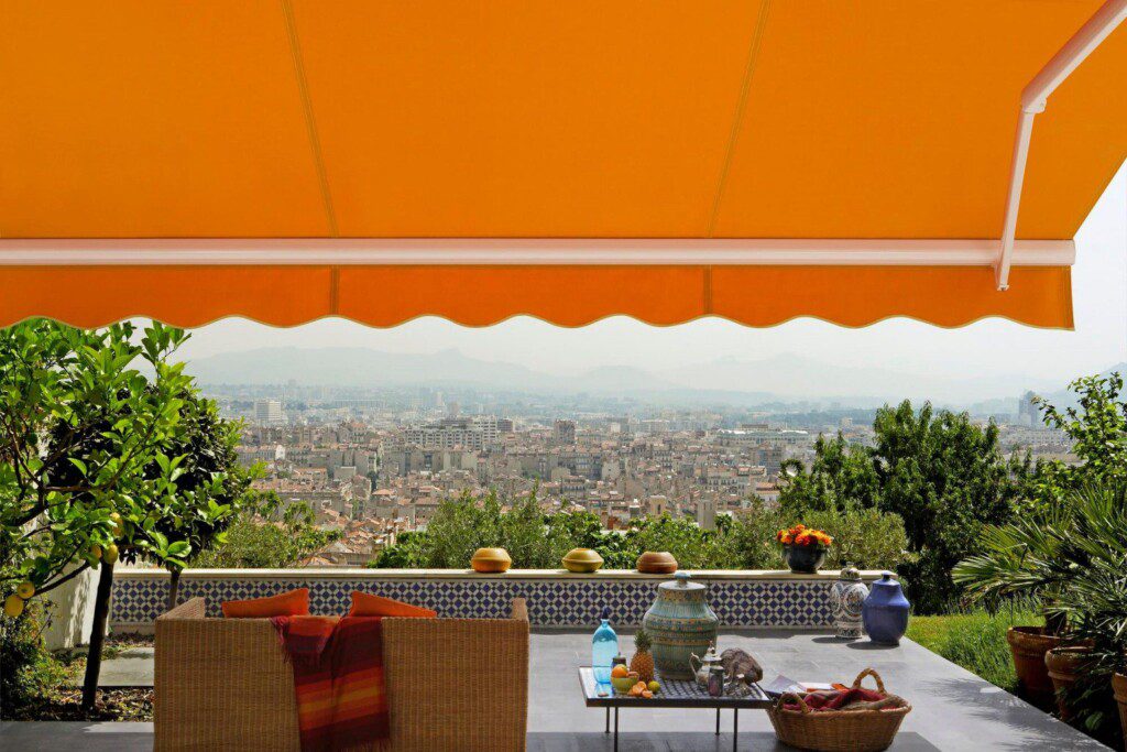 A bright orange awning overlooking a city
