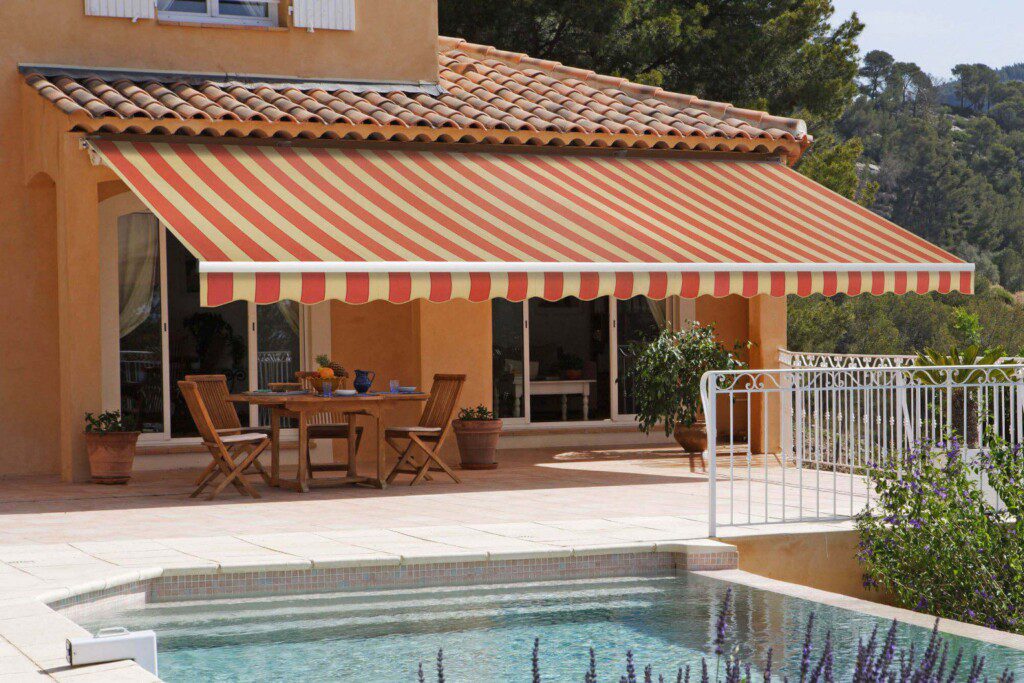 A striped awning covering a patio