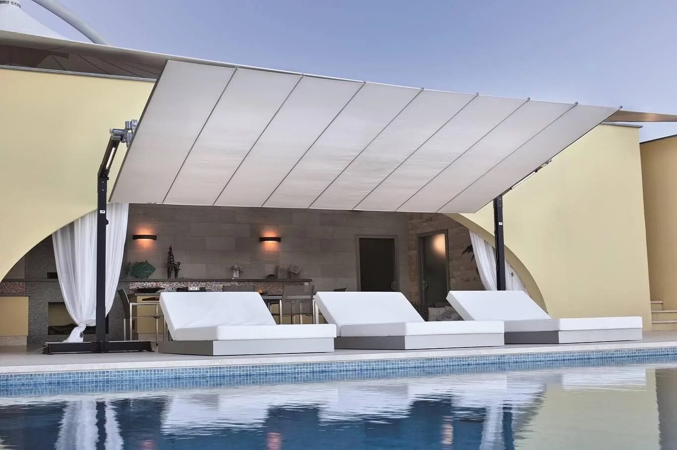 A portable retractable awning near a pool