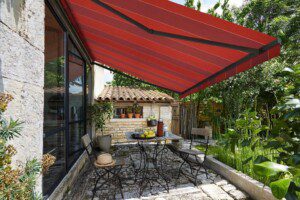 A red striped folding arm awning